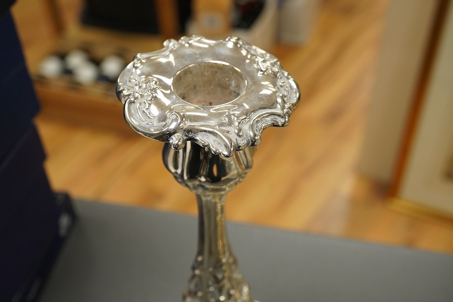 A pair of late Victorian silver candlesticks, with foliate decoration, by Walker & Hall, Sheffield, 1899, height 23cm, weighted.